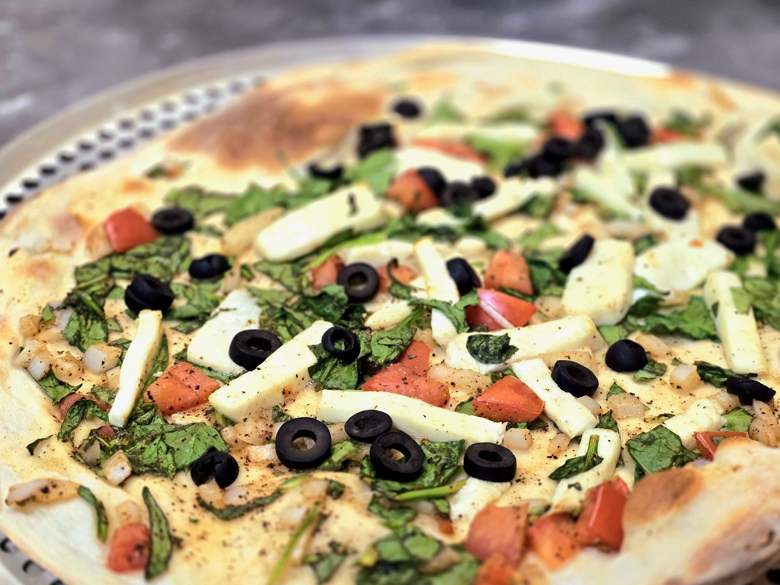 Flatbread topped with vegetables and cheese