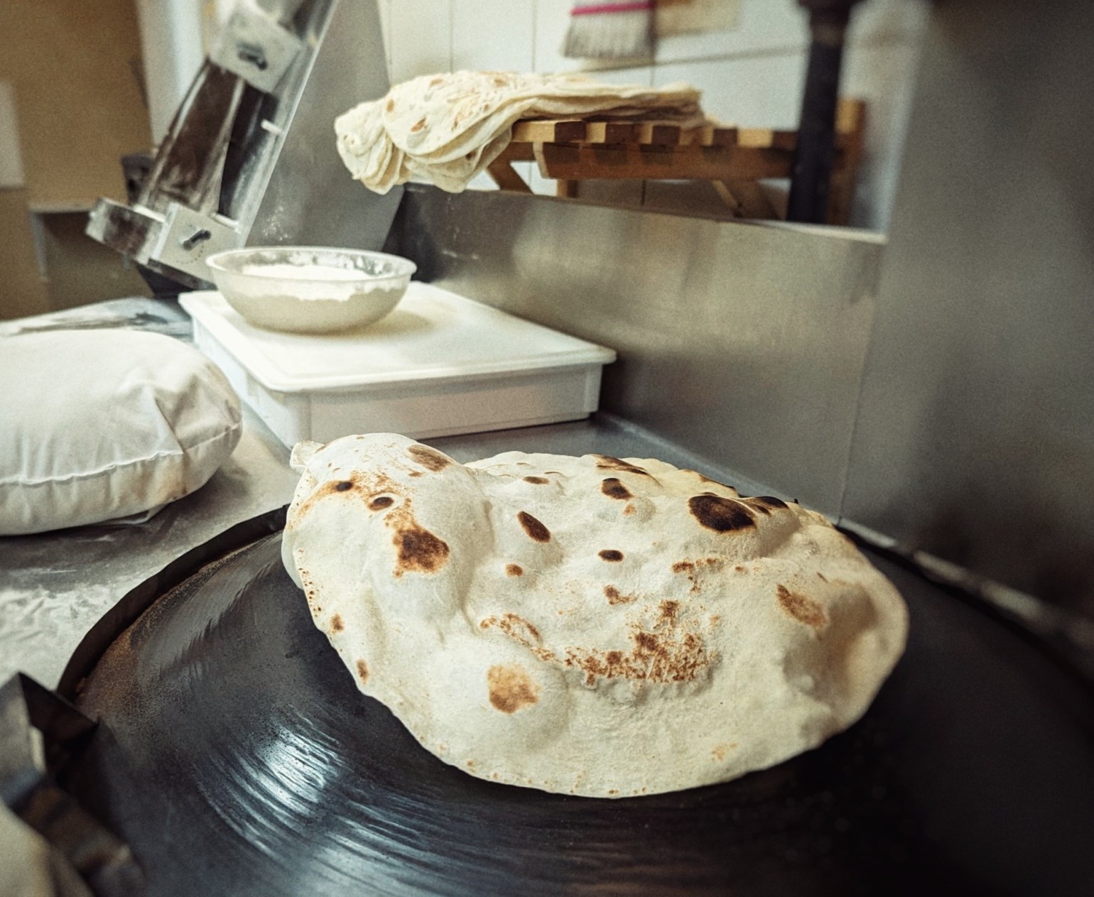 Fresh pita bread puffing on a hot surface