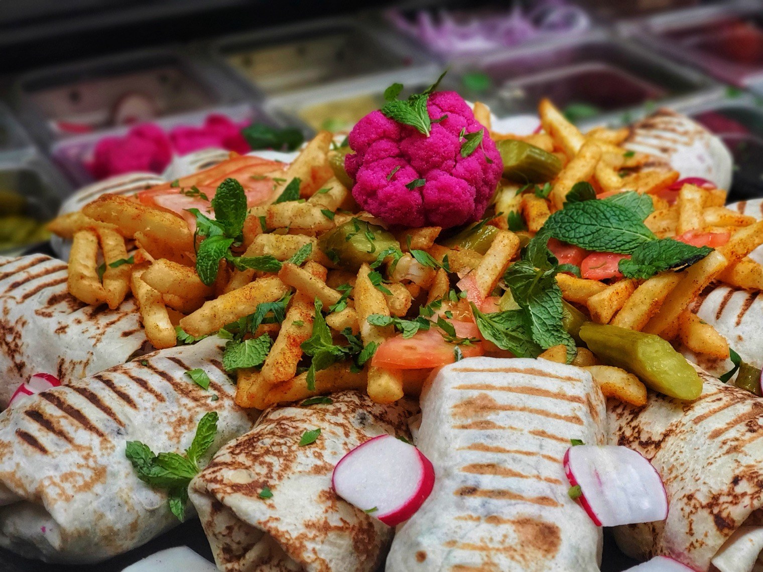 A full Georgie's plate with pita, vegetables, rice, and grilled meat