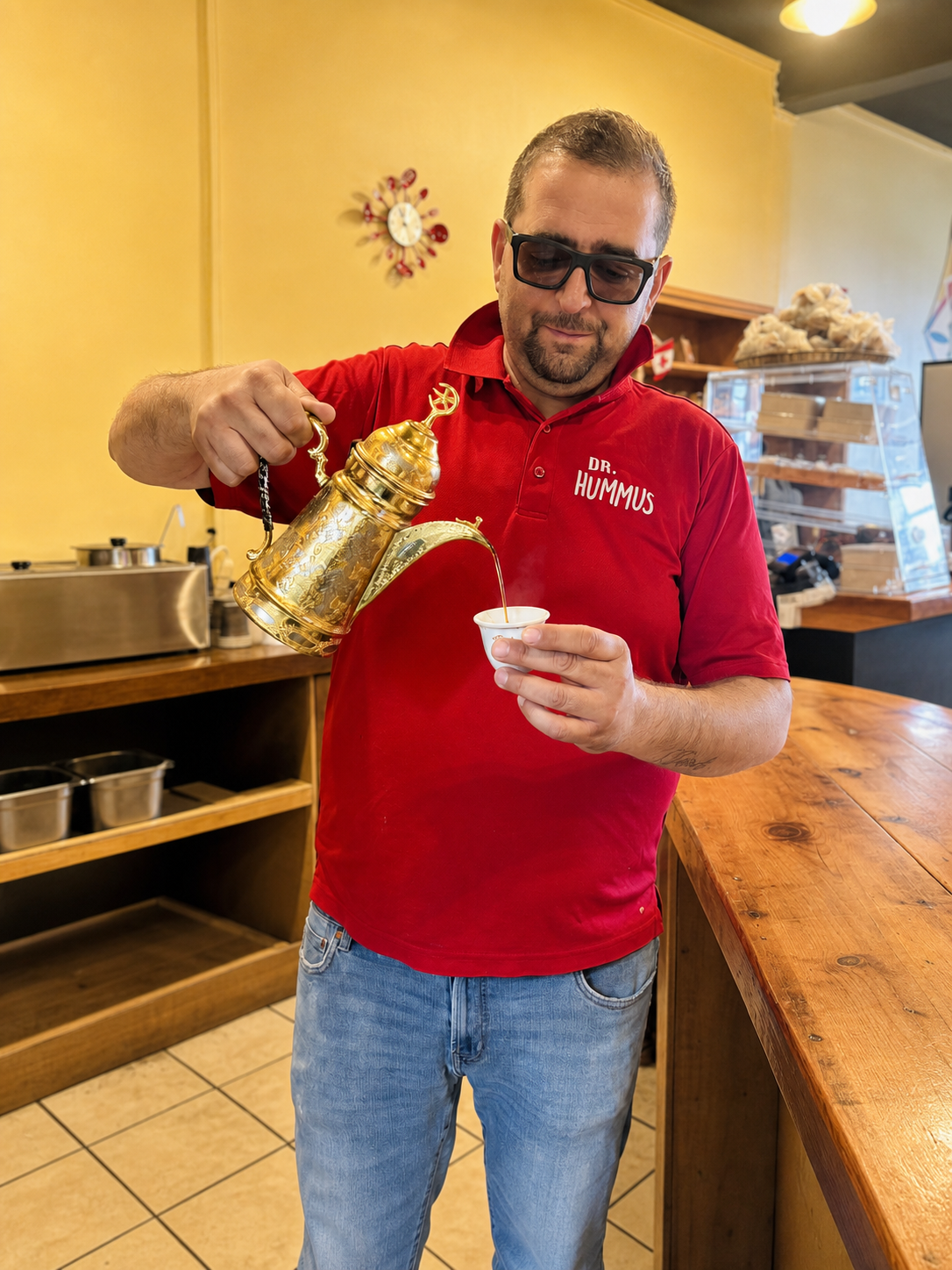 George pouring Syrian tea at Georgie's.