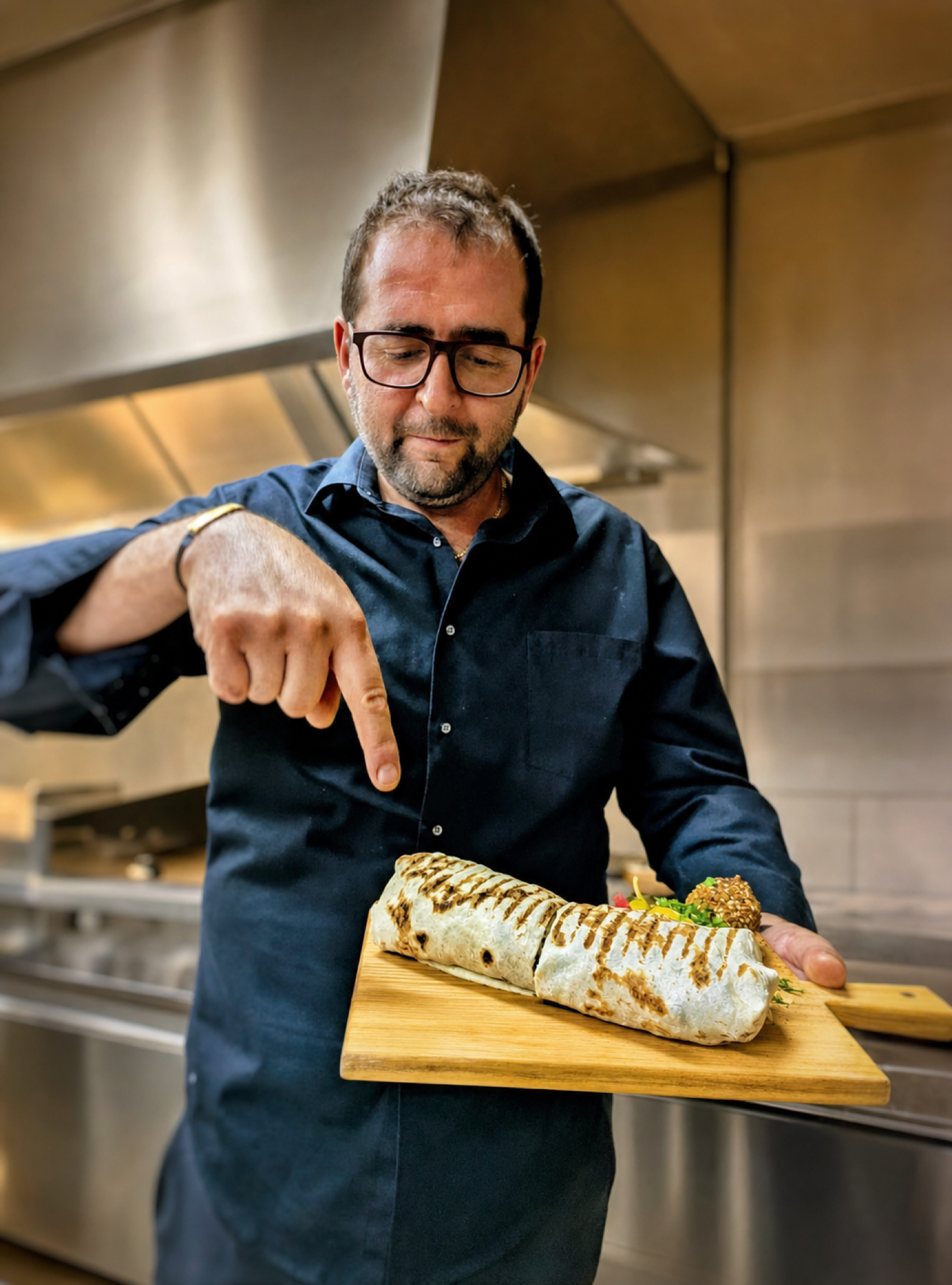 George preparing a shawarma wrap in Georgie's kitchen.